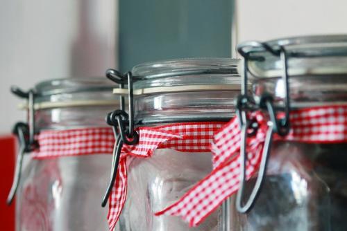 glass-storage-jars with red white checked ribbon trim